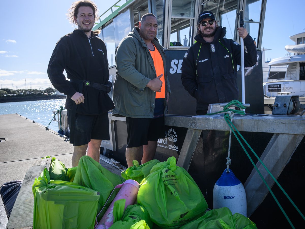 Bags of collected rubbish piled on the dock beside the Sea Cleaners vessel