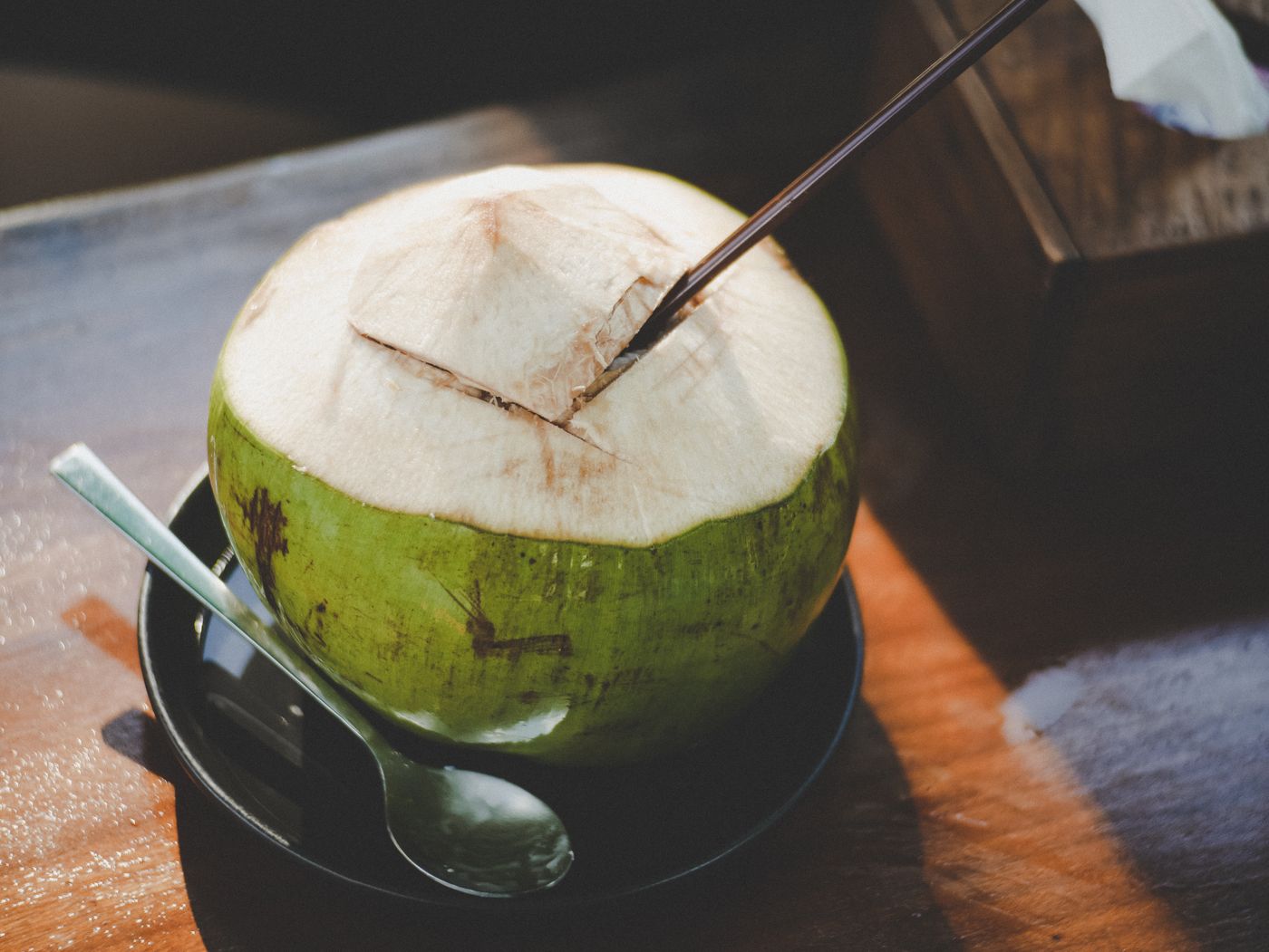 Fresh young coconut with a straw — Pacific coconut water